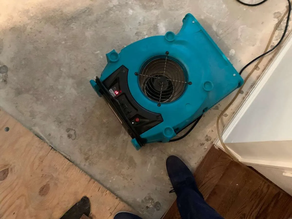 Air mover drying subfloor during Commercial Water Damage Restoration in Stone Mountain